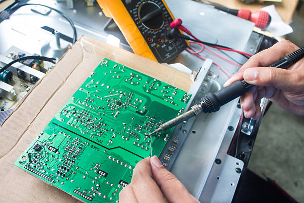 Technician repairing a television.